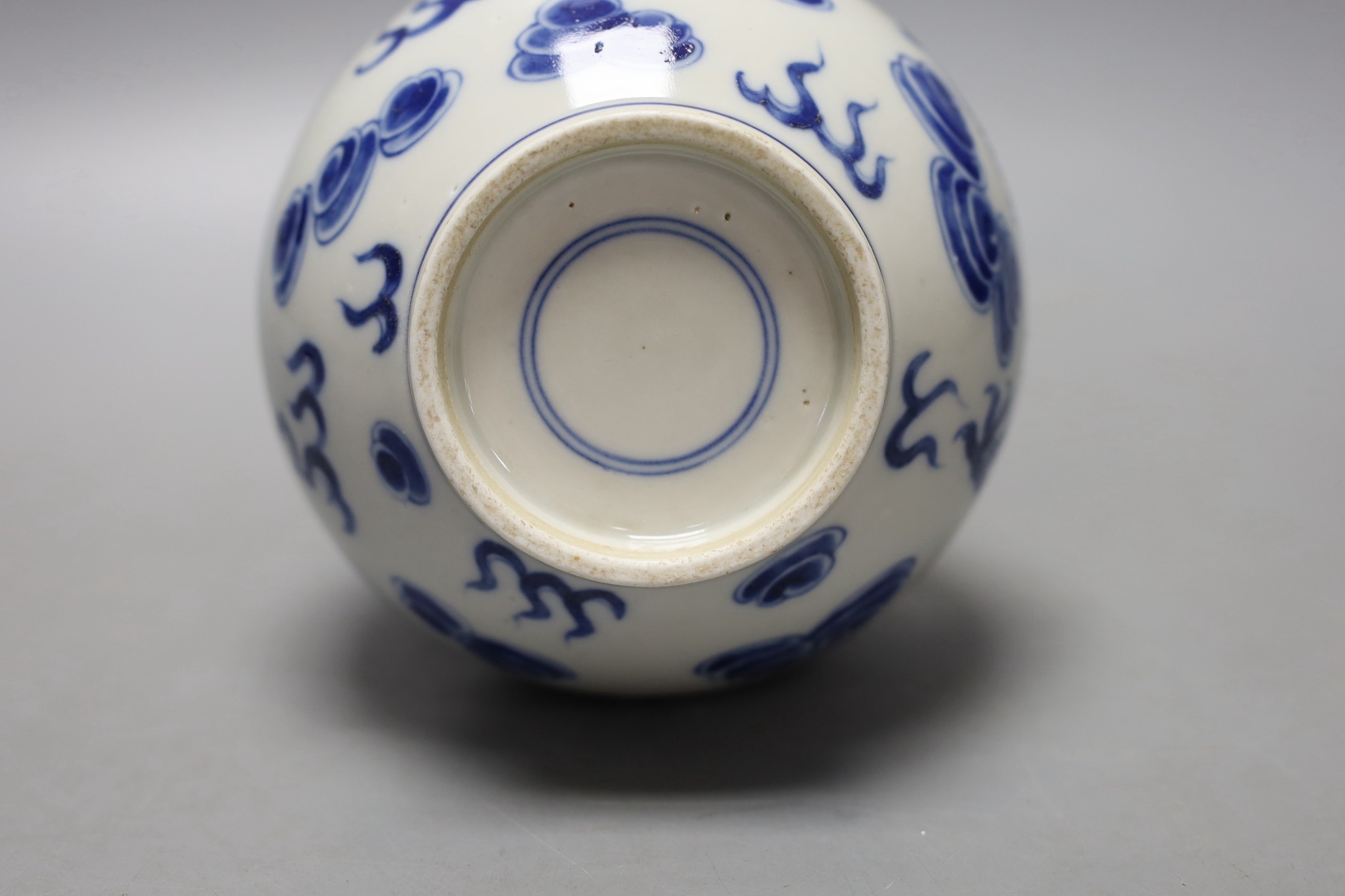 A Chinese blue and white ‘dragon and phoenix’ bottle vase, 23 cms high.